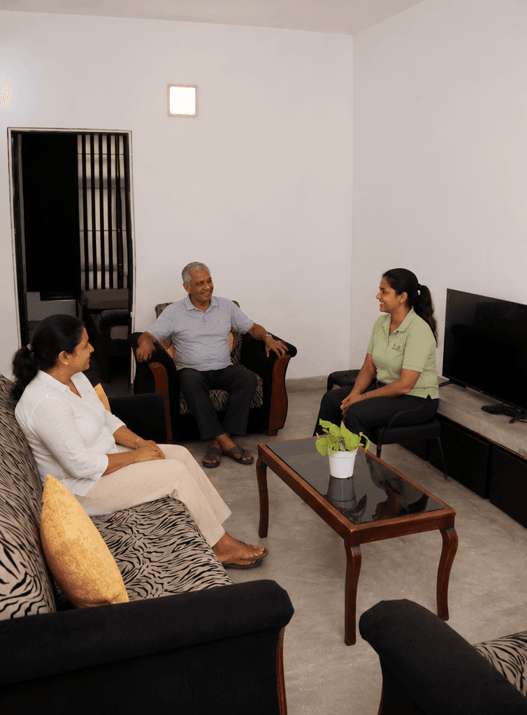 Compassionate caregiver assisting an elderly resident at True Care Senior Wellness Home